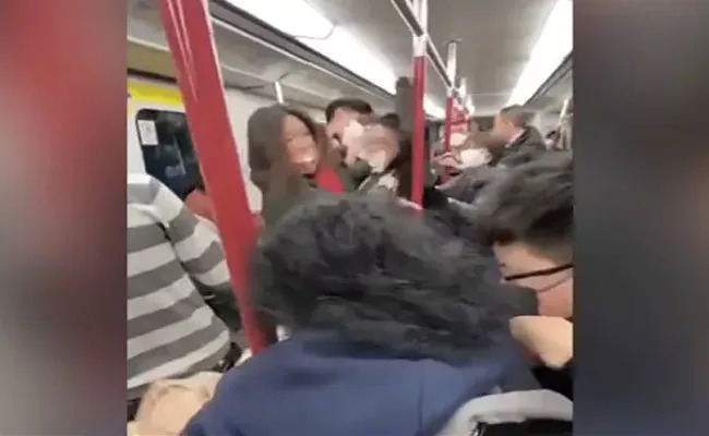 Man And Woman Fighting On Crowded Hong Kong Train Video Viral - Sakshi