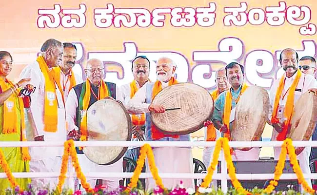 Narendra Modi leads BJP attack on Congress promise to ban Bajrang Dal from the birthplace of Hanuman - Sakshi