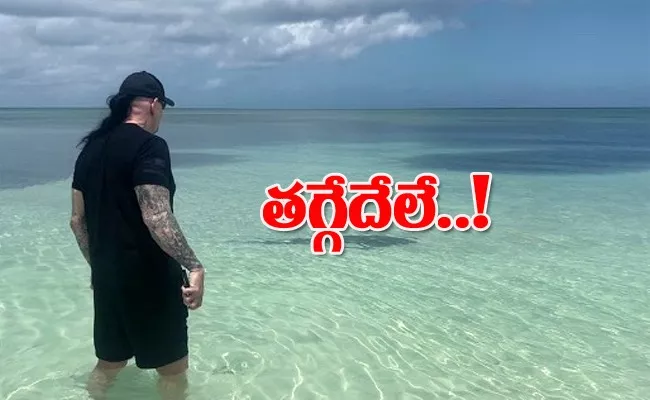 Undertaker Protects Wife Michelle McCool From Shark - Sakshi