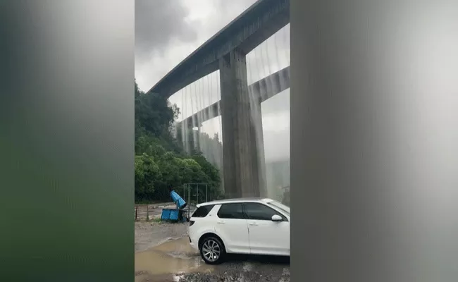 china rains bridge overflows with water after heavy rain in mianyang - Sakshi