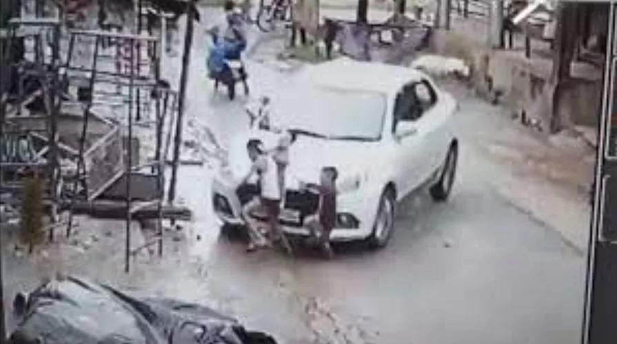 Man Tries To Crush Three Children Under Car Wheels - Sakshi