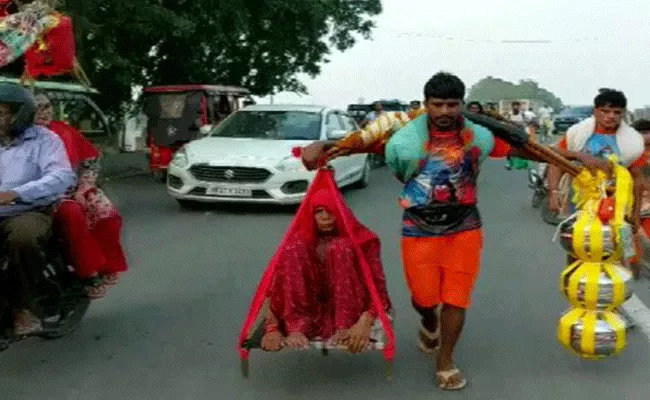 Young devotee carries mother and Ganga water in Kanwar Yatra in Haridwar - Sakshi