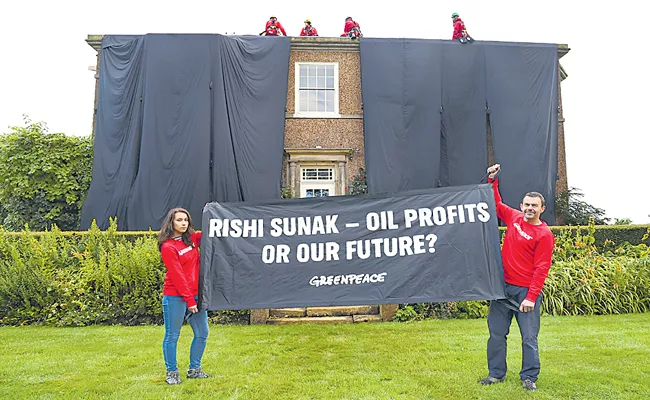 Greenpeace oil protesters cover Rishi Sunak home in black fabric - Sakshi