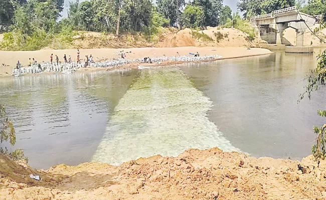 Temporary road on Jampannawagu - Sakshi