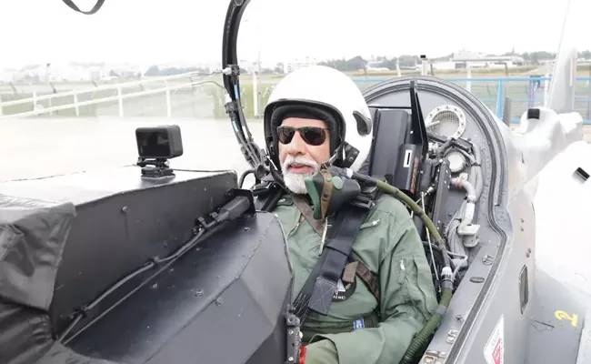 PM Modi Flies In Light Combat Tejas Fighter Jet - Sakshi