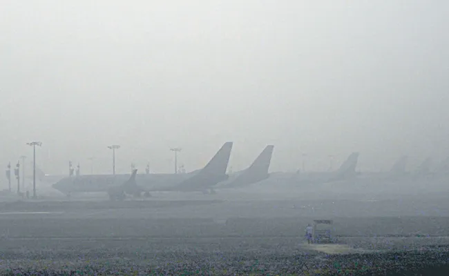 Low visibility hits many parts of Delhi amid dense fog, trains delayed - Sakshi