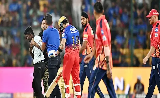 Is Virat Kohli Fan Thrashed By Security For Hugging RCB Star Mid Match - Sakshi