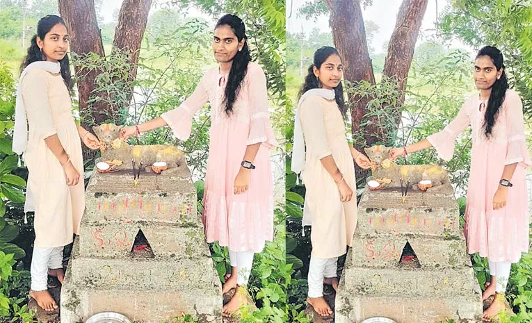 Sisters tying rakhi to the dogs grave