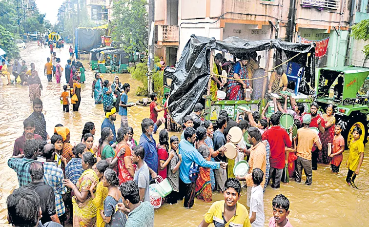  ఆదివారం విజయవాడలోని జక్కంపూడి కాలనీలో ఒక స్వచ్ఛంద సంస్థ పంపిణీ చేస్తున్న ఆహారం కోసం వరద బాధితుల అవస్థలు  