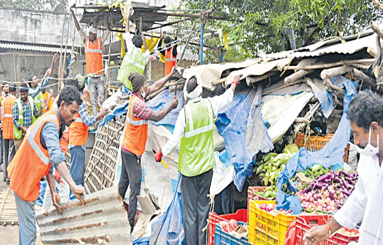 Police and municipal officials demolished over 200 shops in ongole market 