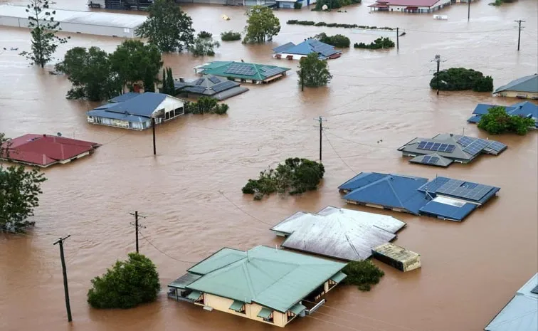 One dead in Queensland as floodwaters rage