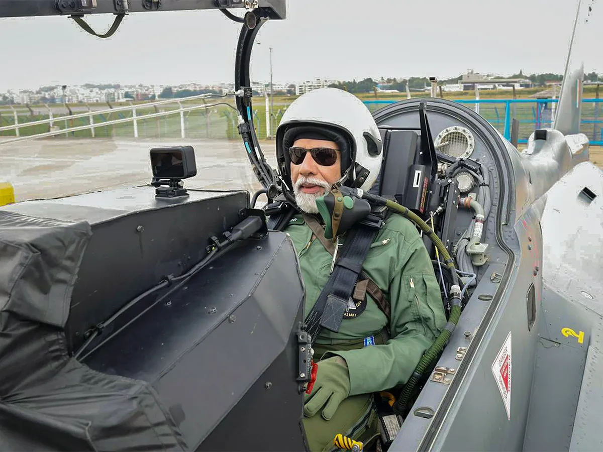 Narendra Modi during taking a sortie on the Tejas in Bengaluru - Sakshi