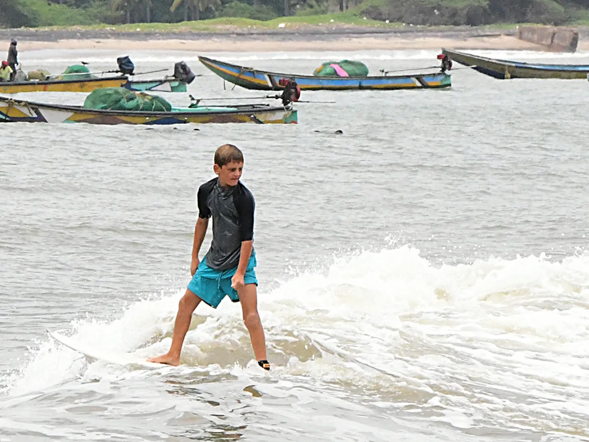 Foreign surfers ride at Visakhapatnam Photos